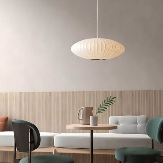 Minimalist indoor disk-shaped silk pendant lighting in modern living space.