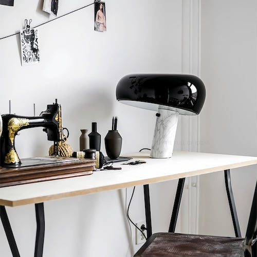 Post-modern marble desk lamp on a stylish workspace table with decorative items.