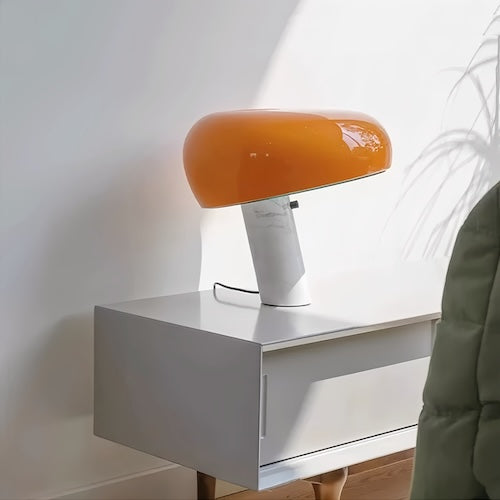 Post-modern marble desk lamp with orange shade in minimalistic design.