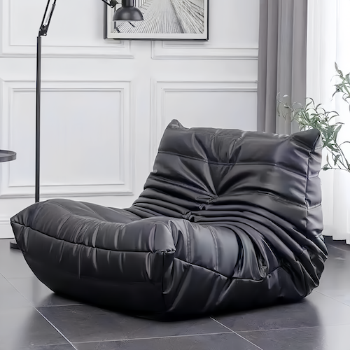 Togo Chair in modern living room setting, featuring plush black upholstery and minimalist design.