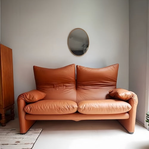 Cassina Replica 2 Seater Leather Sofa in brown with plush cushions in a modern living space.