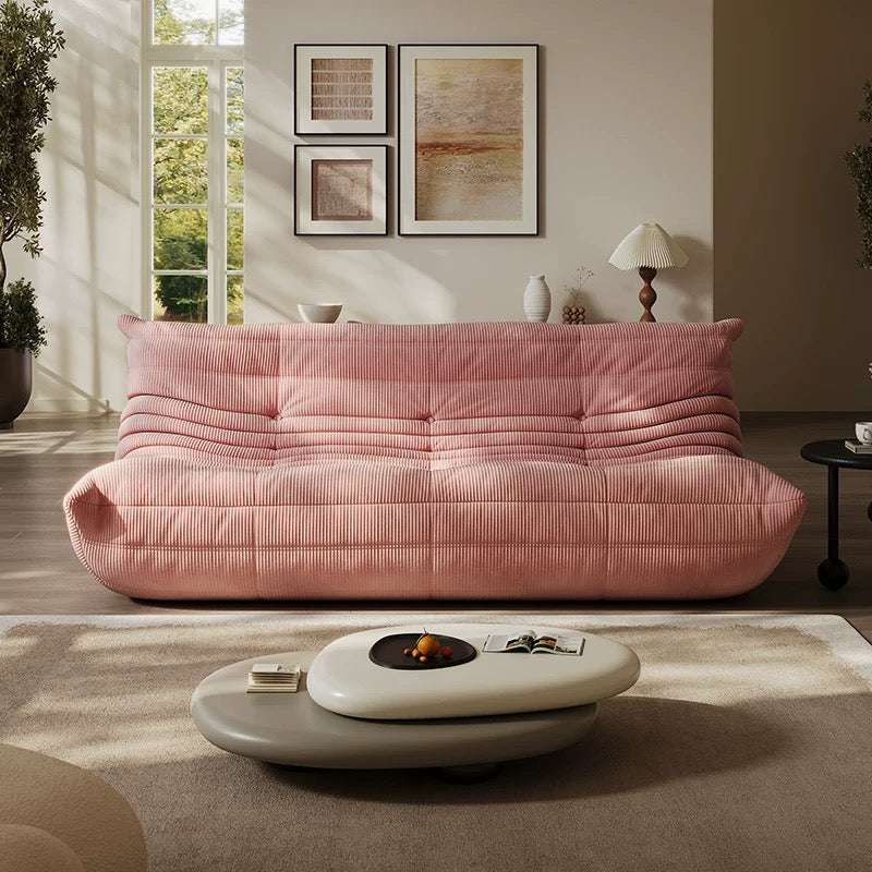 Togo 3 seater sofa in pink corduroy fabric in a stylish living room setting.