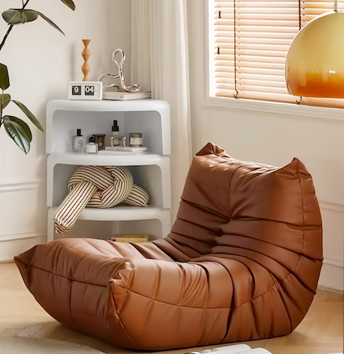 Togo Chair in brown leather finish in modern living room setting.