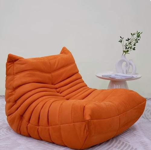 Togo Chair in vibrant orange, minimalist modern design, perfect for living room comfort and style.