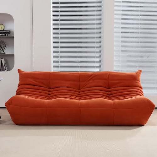 Chic Togo 2-Seater Sofa in orange suede in a modern living room setting - orangme.com