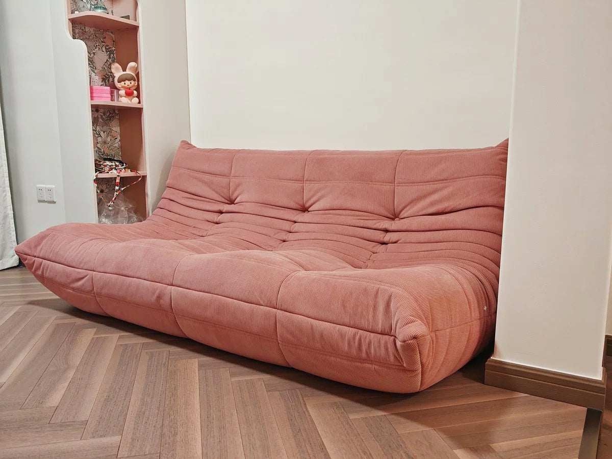 Togo 3 Seater Sofa in pink corduroy in a modern living room setting.
