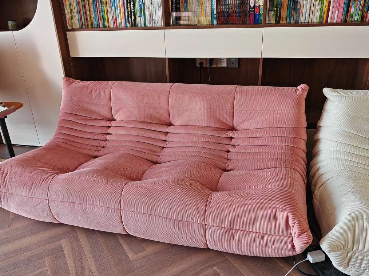 Pink Togo 3 Seater Sofa in corduroy fabric, showcasing modern design and comfort in a living room setting.