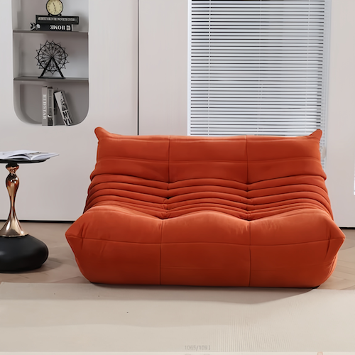 Chic Togo 2-Seater Sofa in orange suede in a modern living room setting - orangme.com