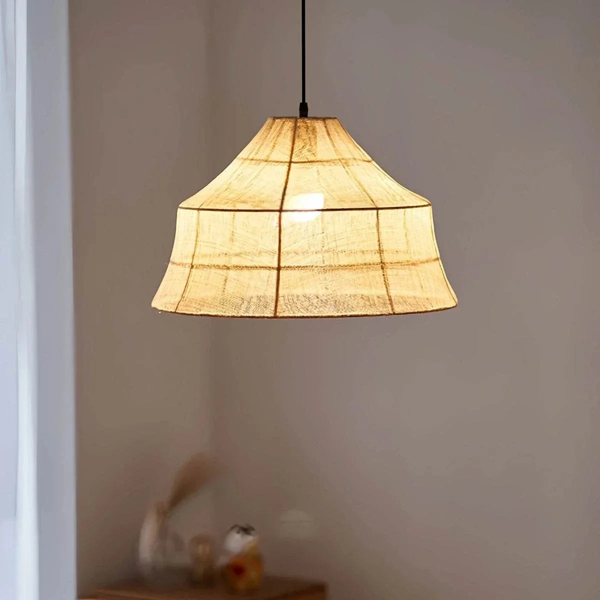 Japanese Zen fabric pendant light with soft warm glow and minimalist retro design hanging in a tea room