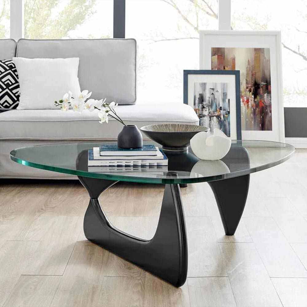 Noguchi Coffee Table with glass top and interlocking wood base in modern living room.