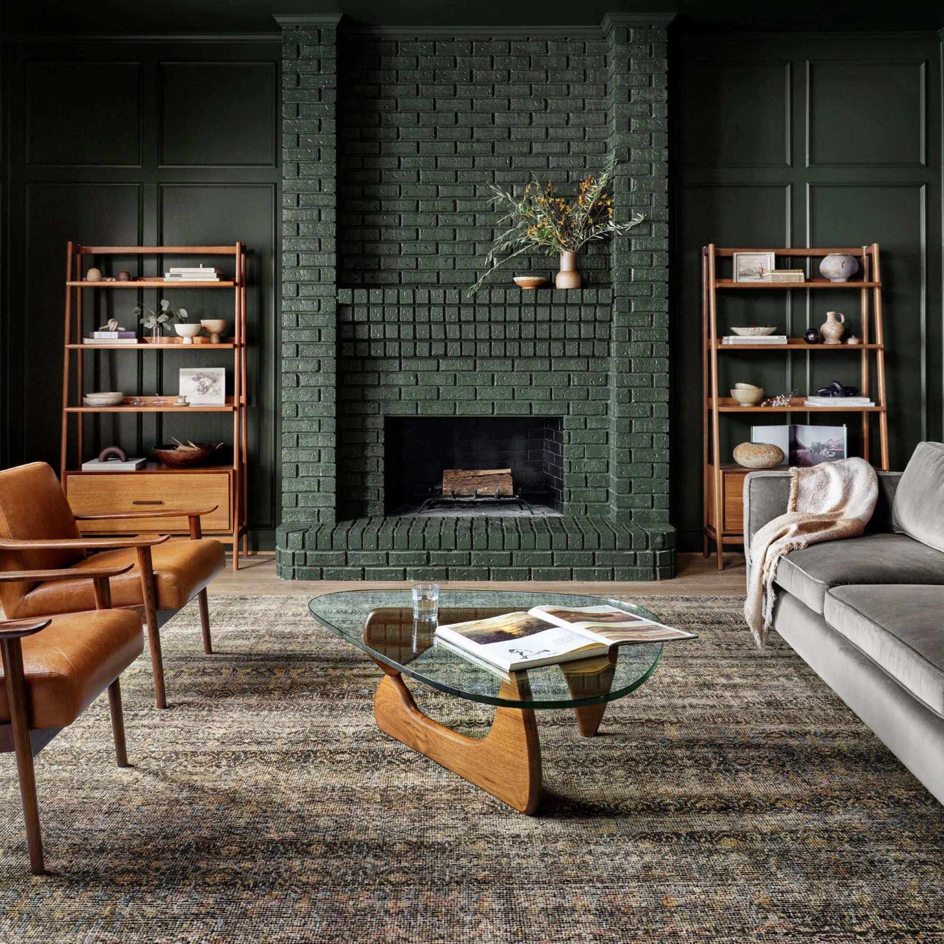 Noguchi Coffee Table with sculptural wooden base and freeform glass top in a modern living room setting.