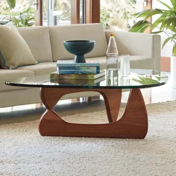 Noguchi Coffee Table with interlocking wooden base and glass top in modern living room.