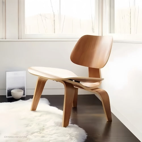 Eames Molded Plywood Lounge Chair in mid-century modern design, shown in natural wood finish, set in a contemporary interior space.