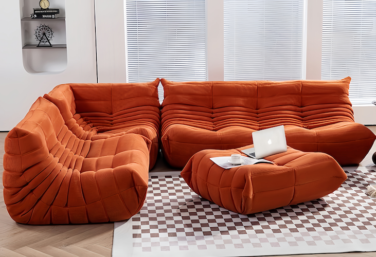 Chic Togo Sofa in orange suede in a modern living room setting - orangme.com