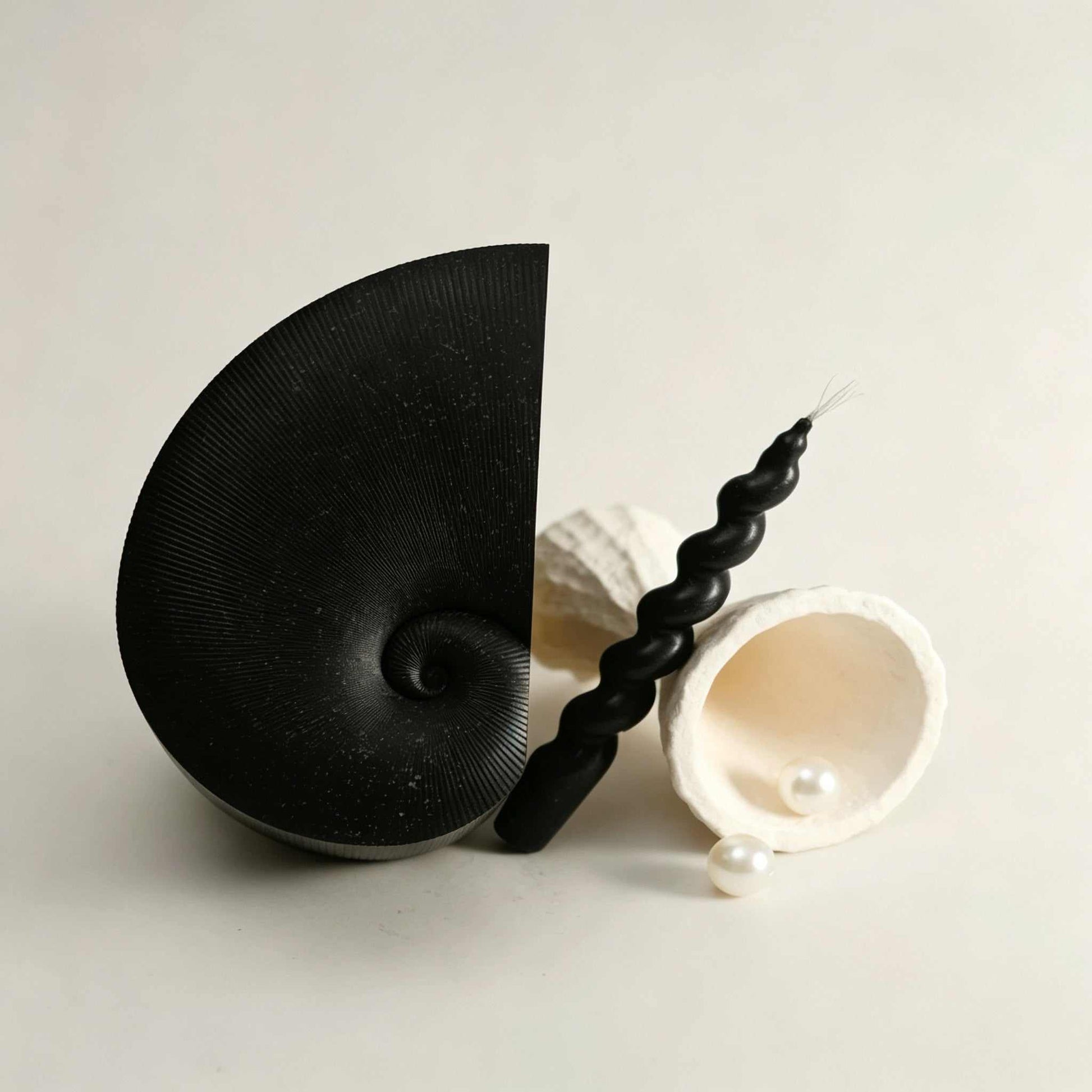 Ink-Splash Conch Tissue Box with artistic spiral design and metal base for stylish tissue storage in living room