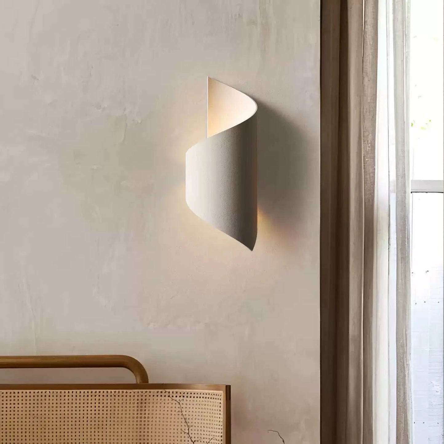 Modern wall lamp on a neutral wall with a window in the background