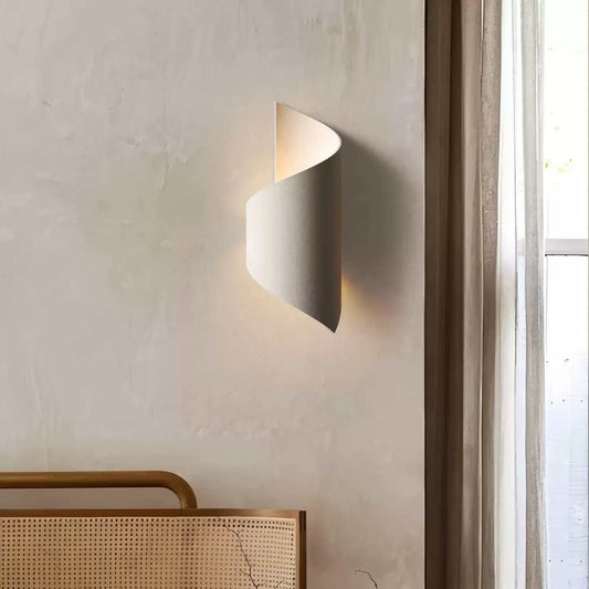 Modern wall lamp on a neutral wall with a window in the background