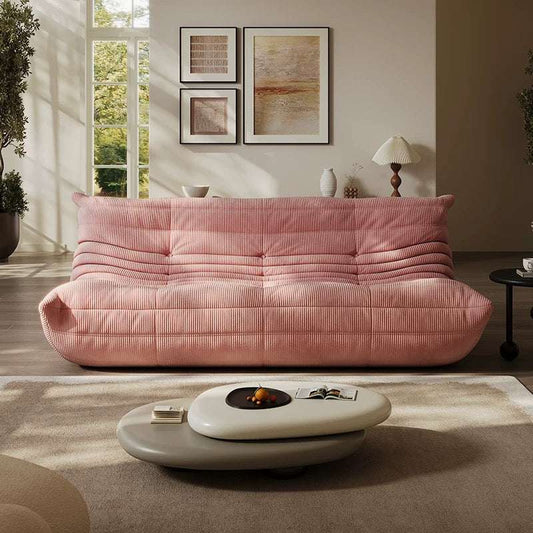 Pink corduroy 3-seater Togo sofa in a stylish living room setting.