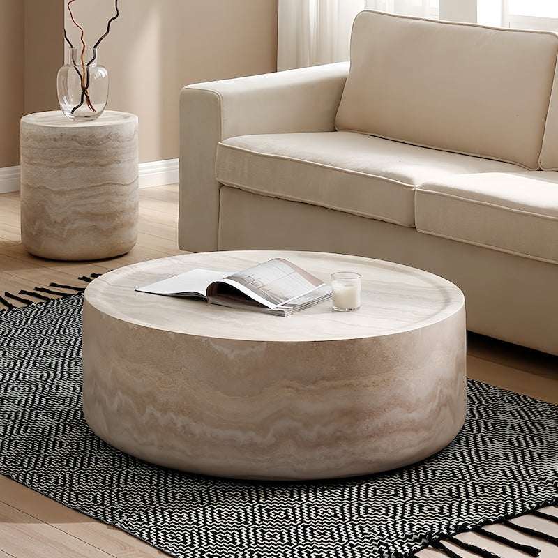Round marble coffee table in a stylish living room setting with beige sofa and patterned rug - orangme.com