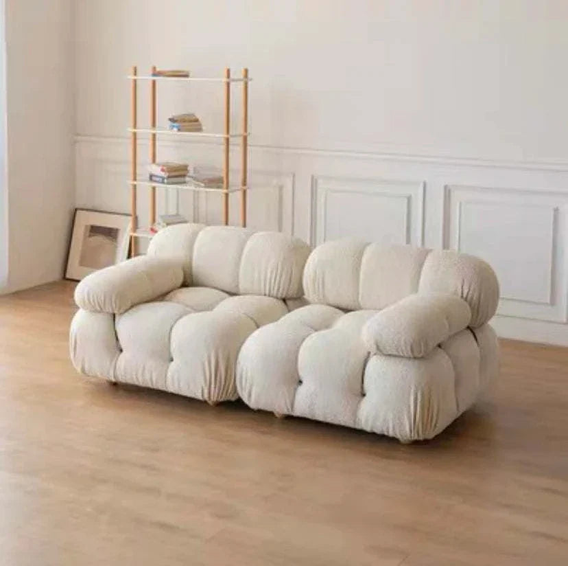 Modern sectional sofa with flexible fabric modules in a living room setting.