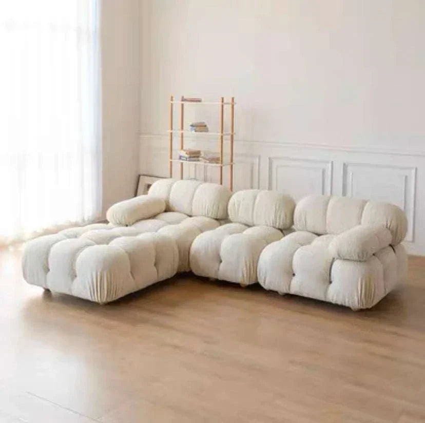 Modern sectional sofa with flexible velvet fabric modules in a living room setting.