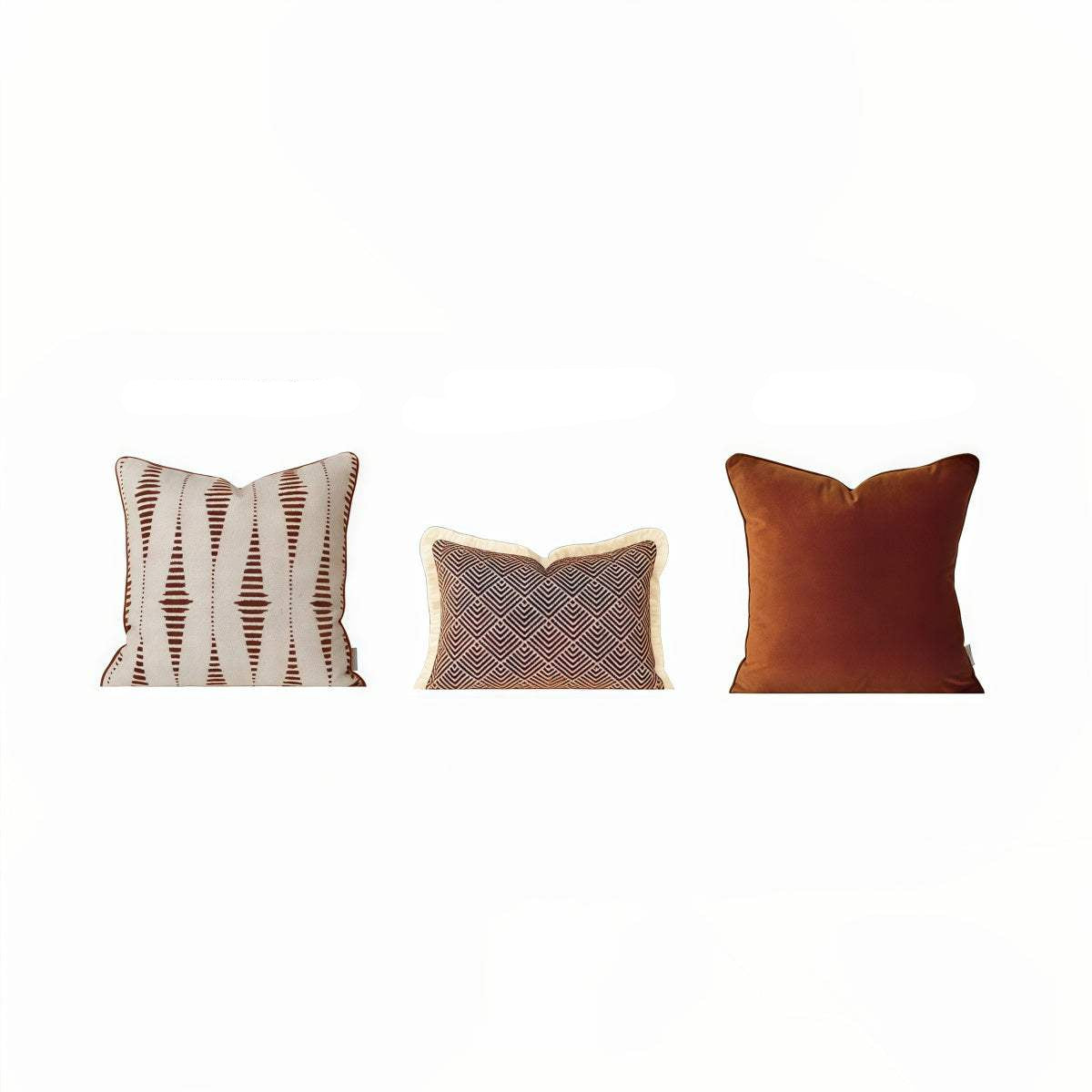 Three square throw pillows shown side by side with printed dimensions above each: a cream pillow with brown ikat-style stripes, a dark blue pillow with a beige geometric pattern and cream border, and a rust-brown solid pillow. Text above reads 17.